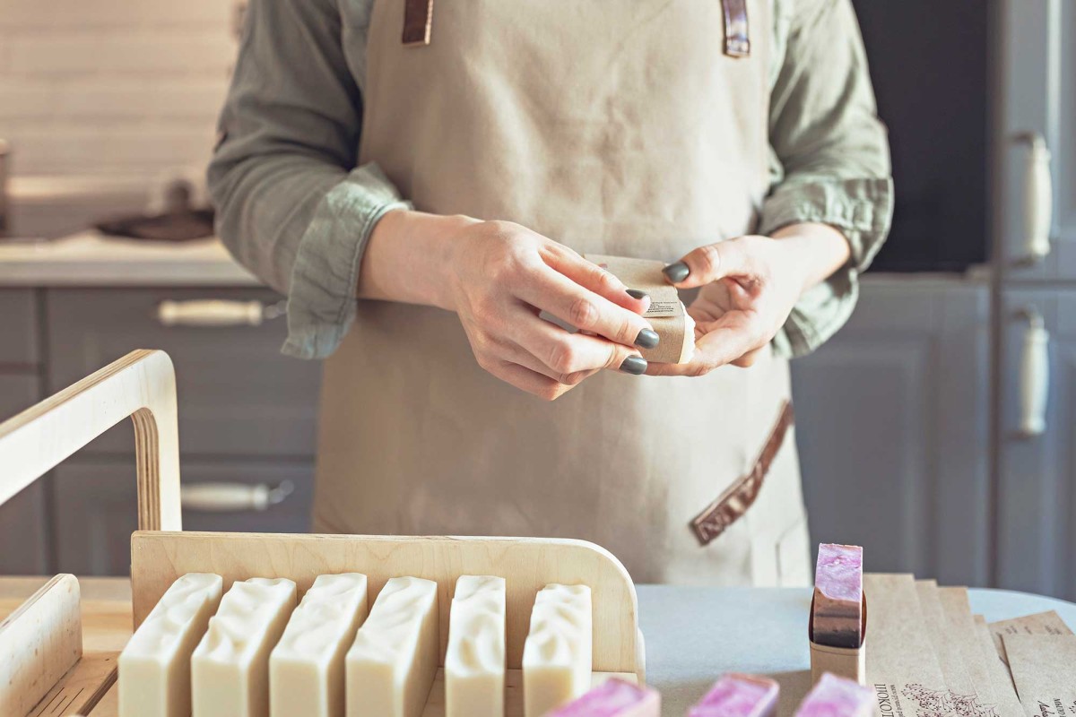 Person crafting handmade soap in workshop