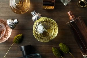 Assorted elegant perfume bottles on wooden surface