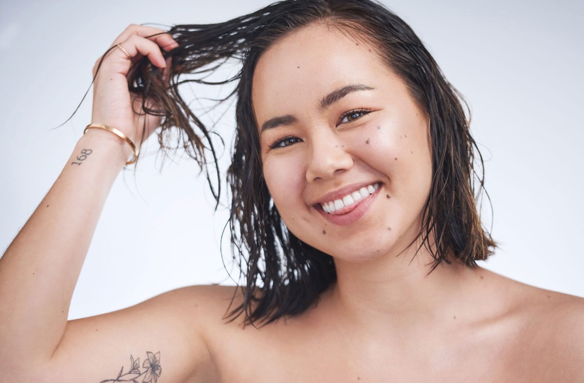 Happy woman with wet hair smiling at camera