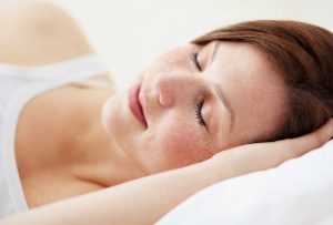 Woman sleeping peacefully white background