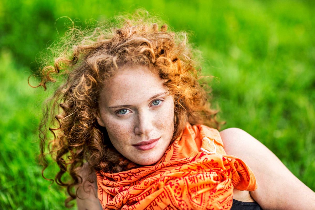 Red-haired woman with green background