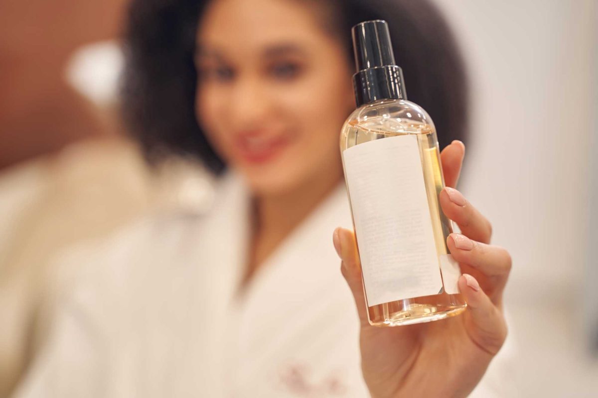 Woman presenting skincare product in a spa