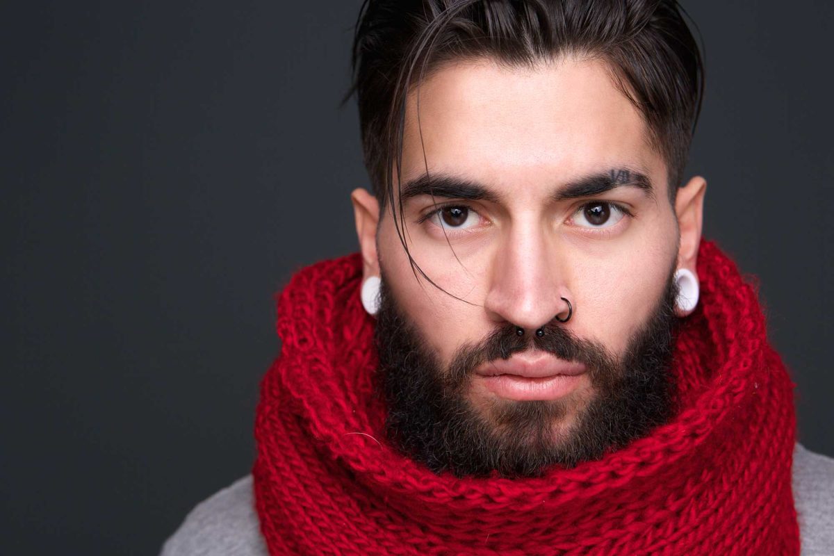 Man with beard wearing red scarf and nose ring